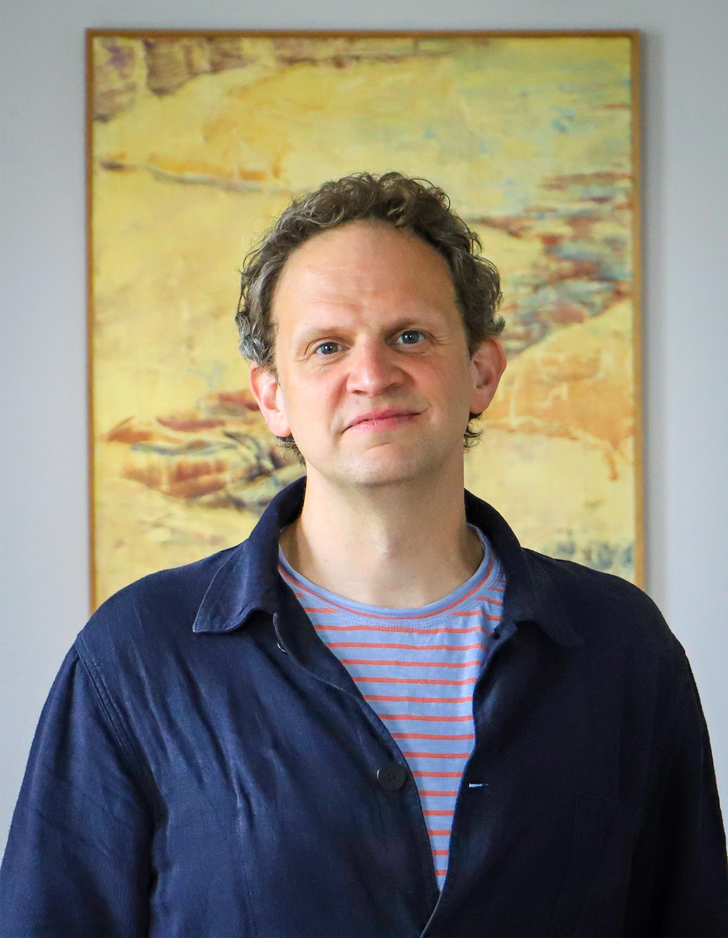 a man standing in front of a painting