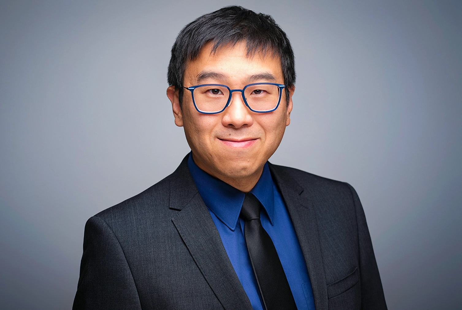 Man in a suit smiling.
