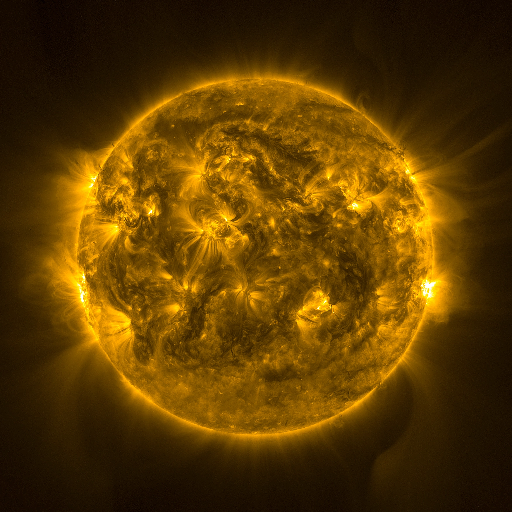 The sun moving towards solar maximum, where the disk is visibly more complex and dynamic, covered in bright active regions, swirling loops, and more flares erupting at the edges.