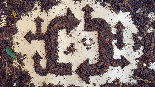 Dirt arranged in the shape of arrows pointing in a circle.