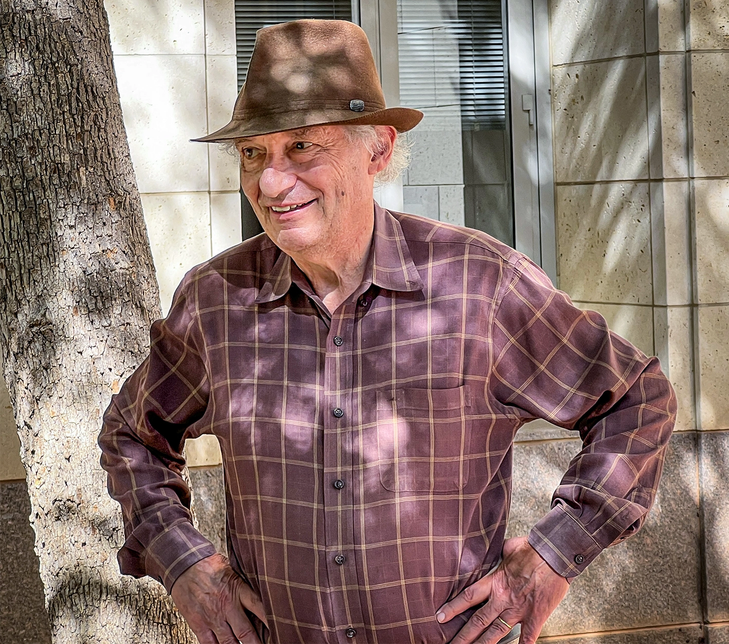 Man wearing a hat and plaid shirt.