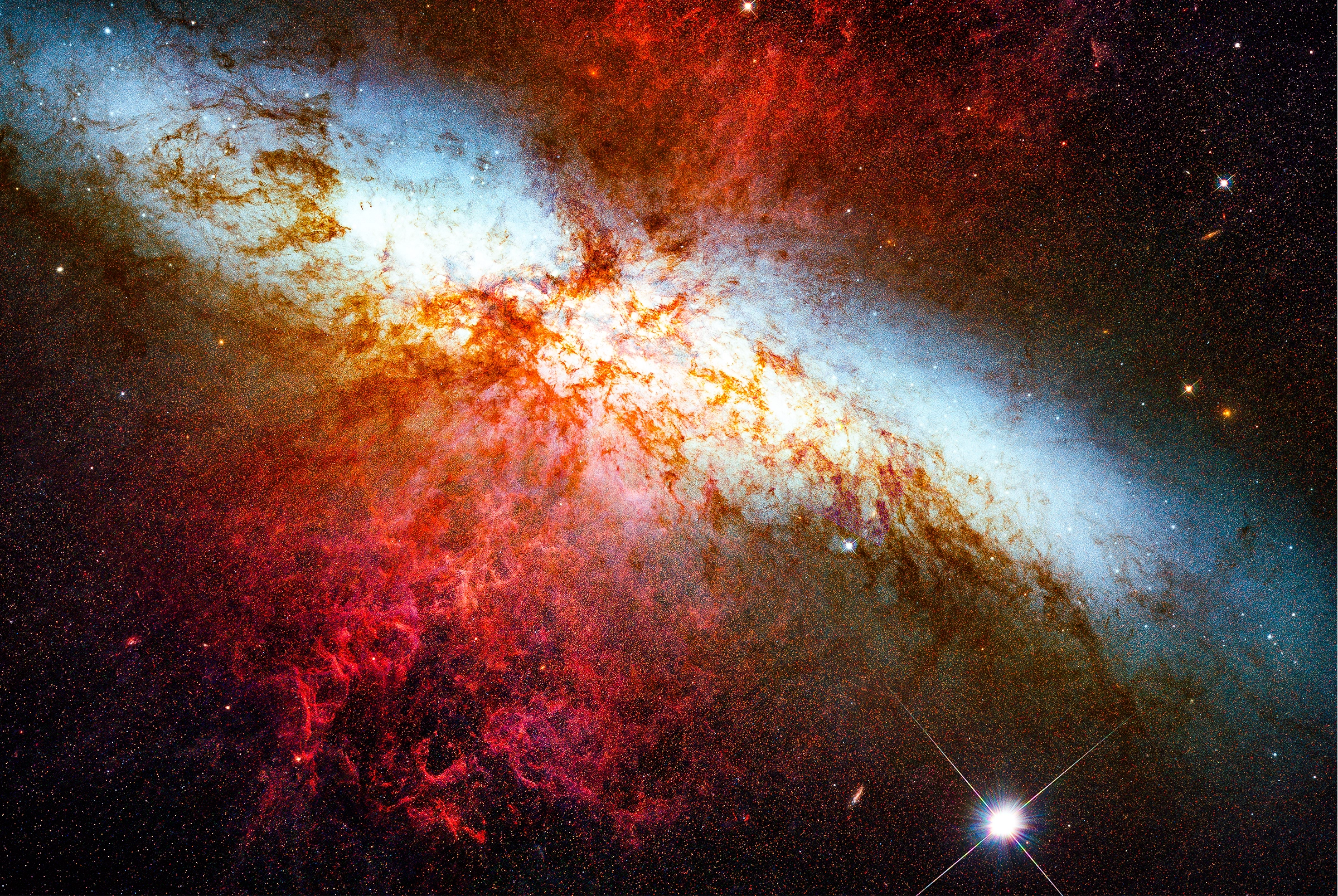 An image shows a bright spot of light against a background of colorful gas and stars.