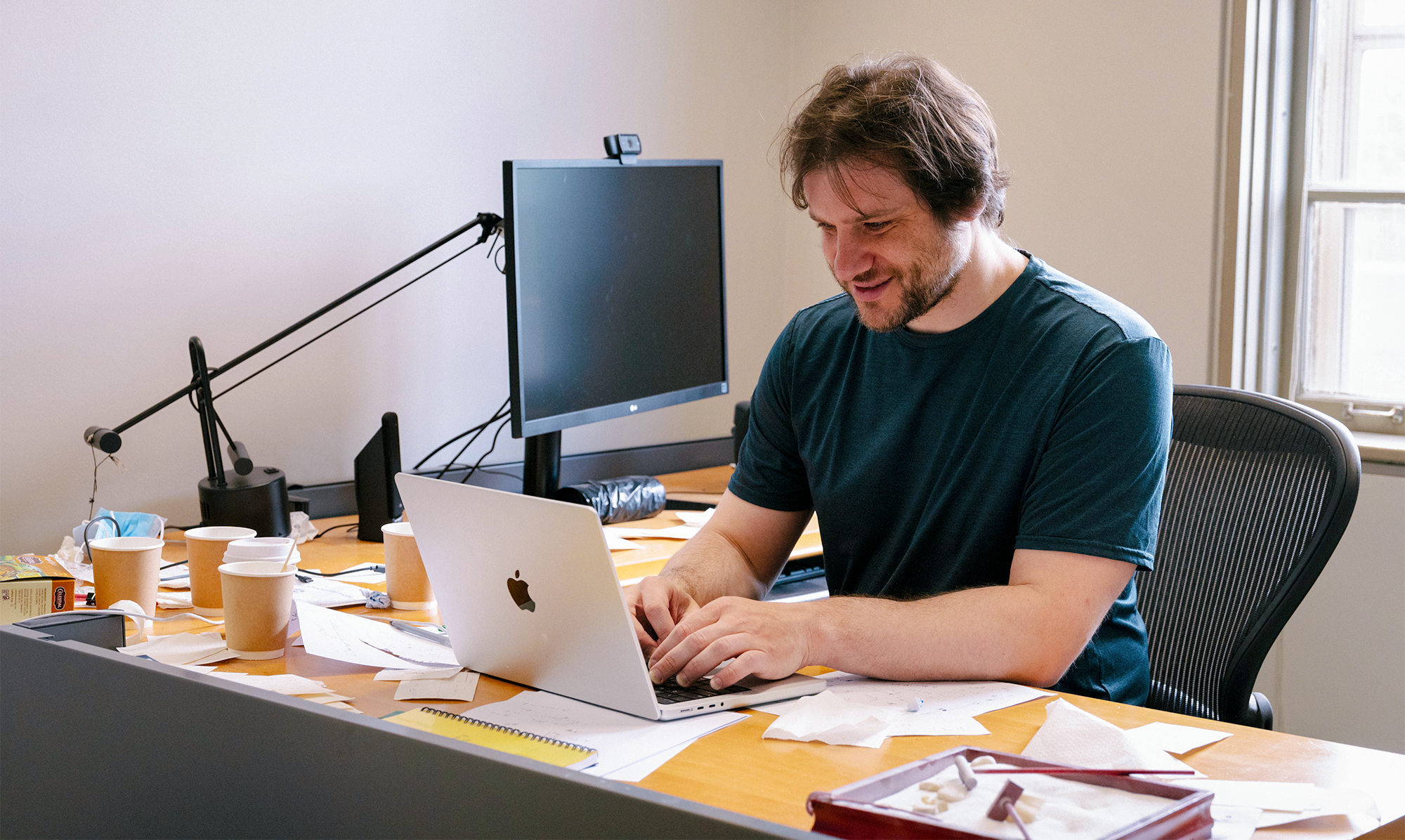 A man at a desk working on a laptop.