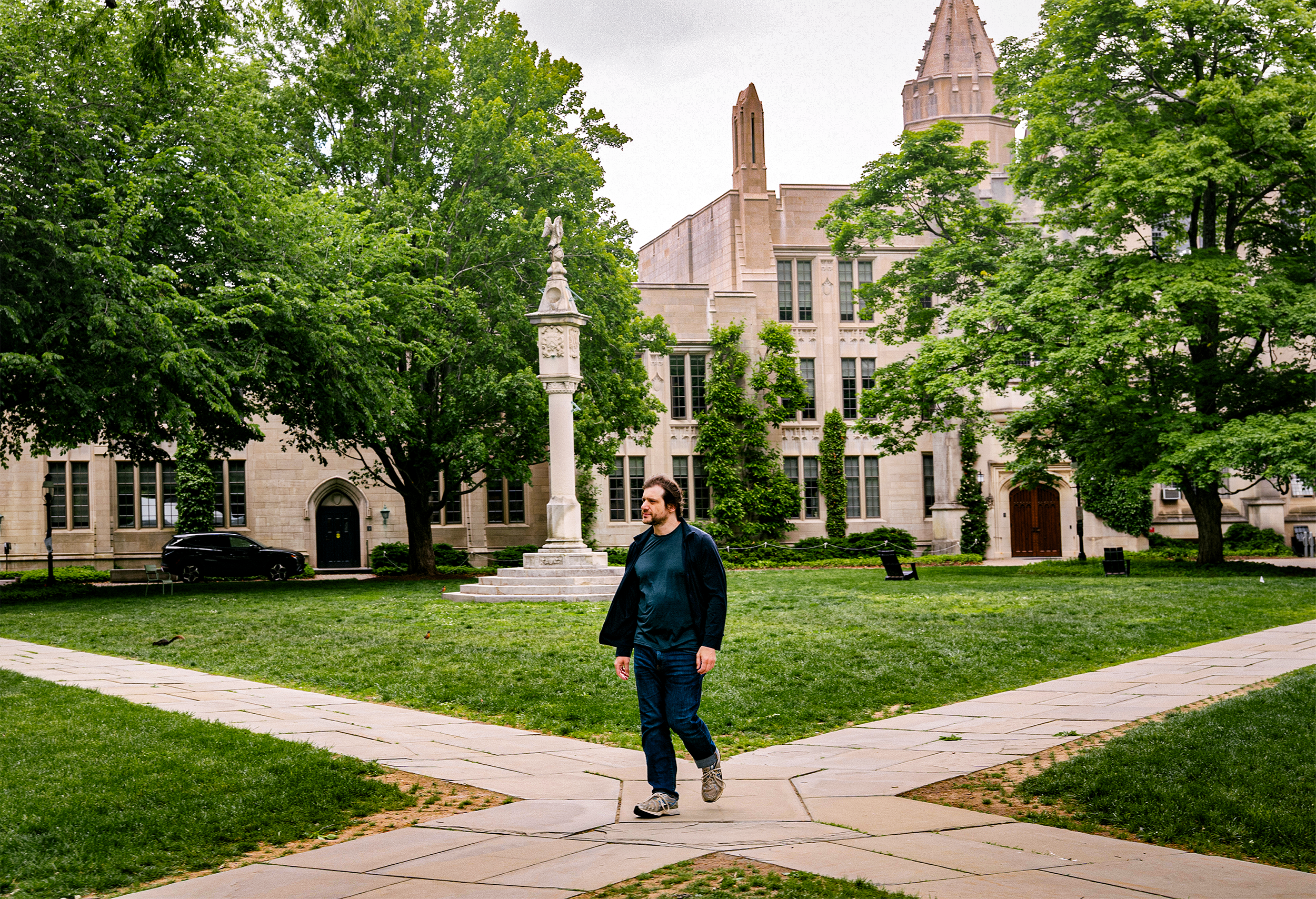 A man walking across a courtyard.