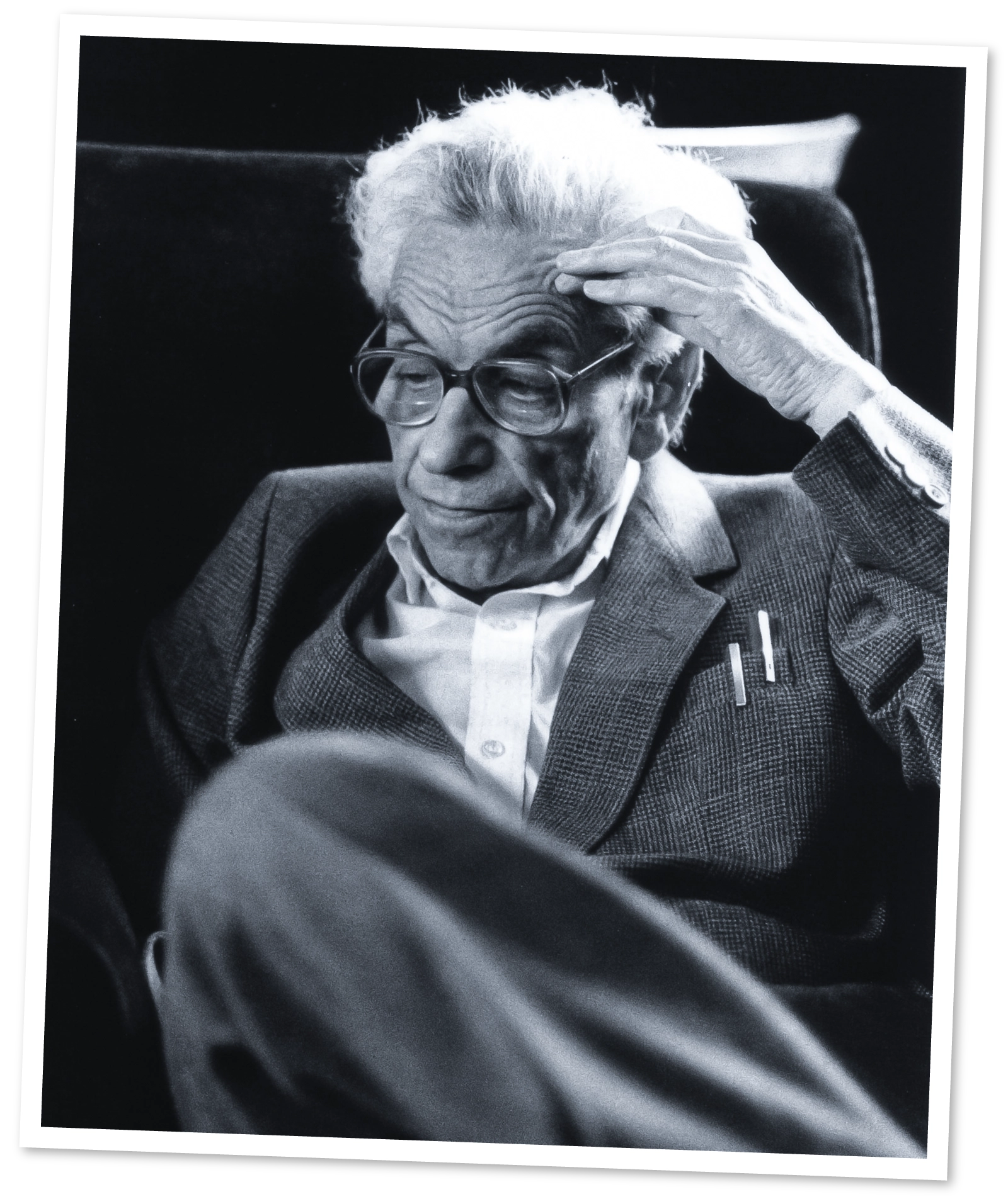 Black-and-white photo of a man sitting.