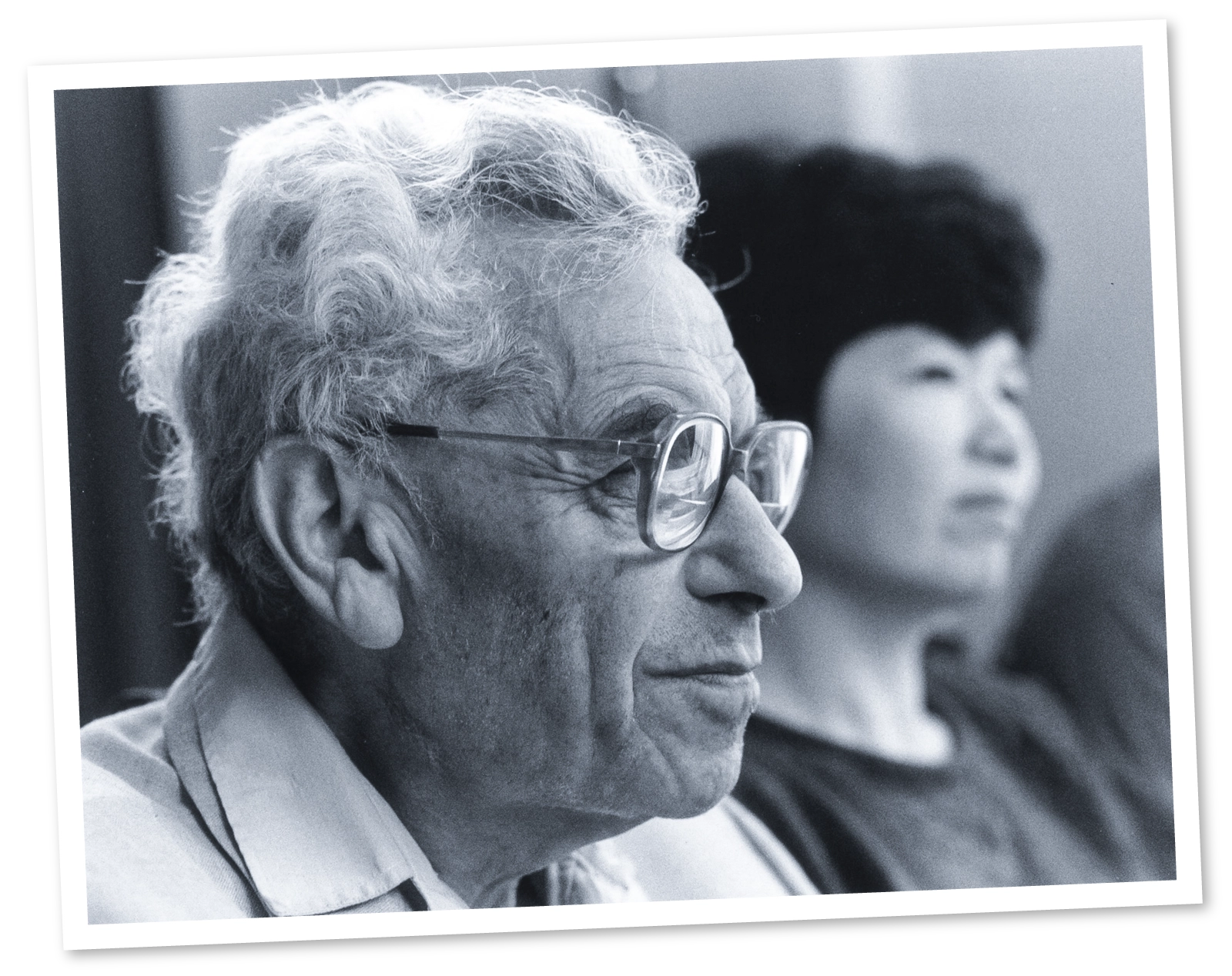 Black-and-white photo of a man in glasses.