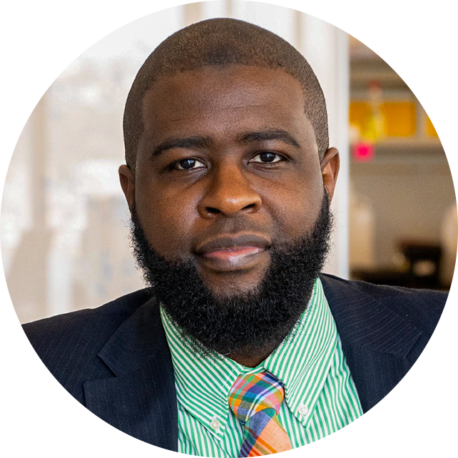 A portrait of a man in a suit and green shirt