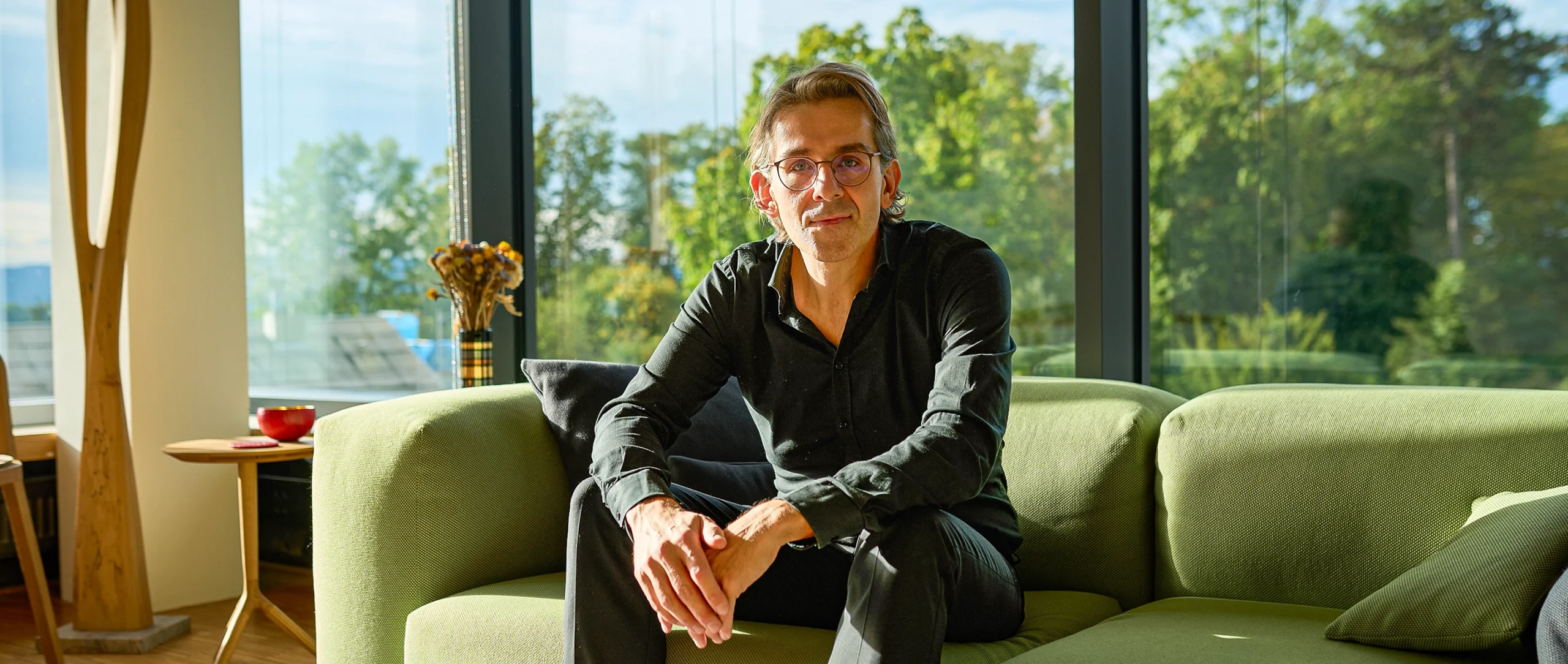 Man sitting on a green couch.