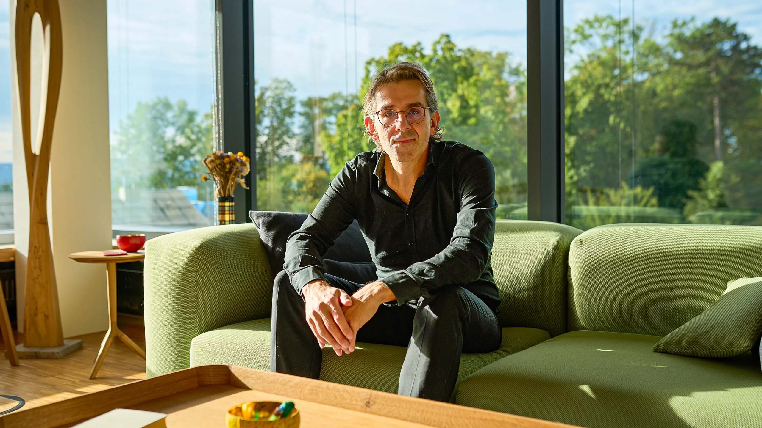 Man sitting on a green couch.