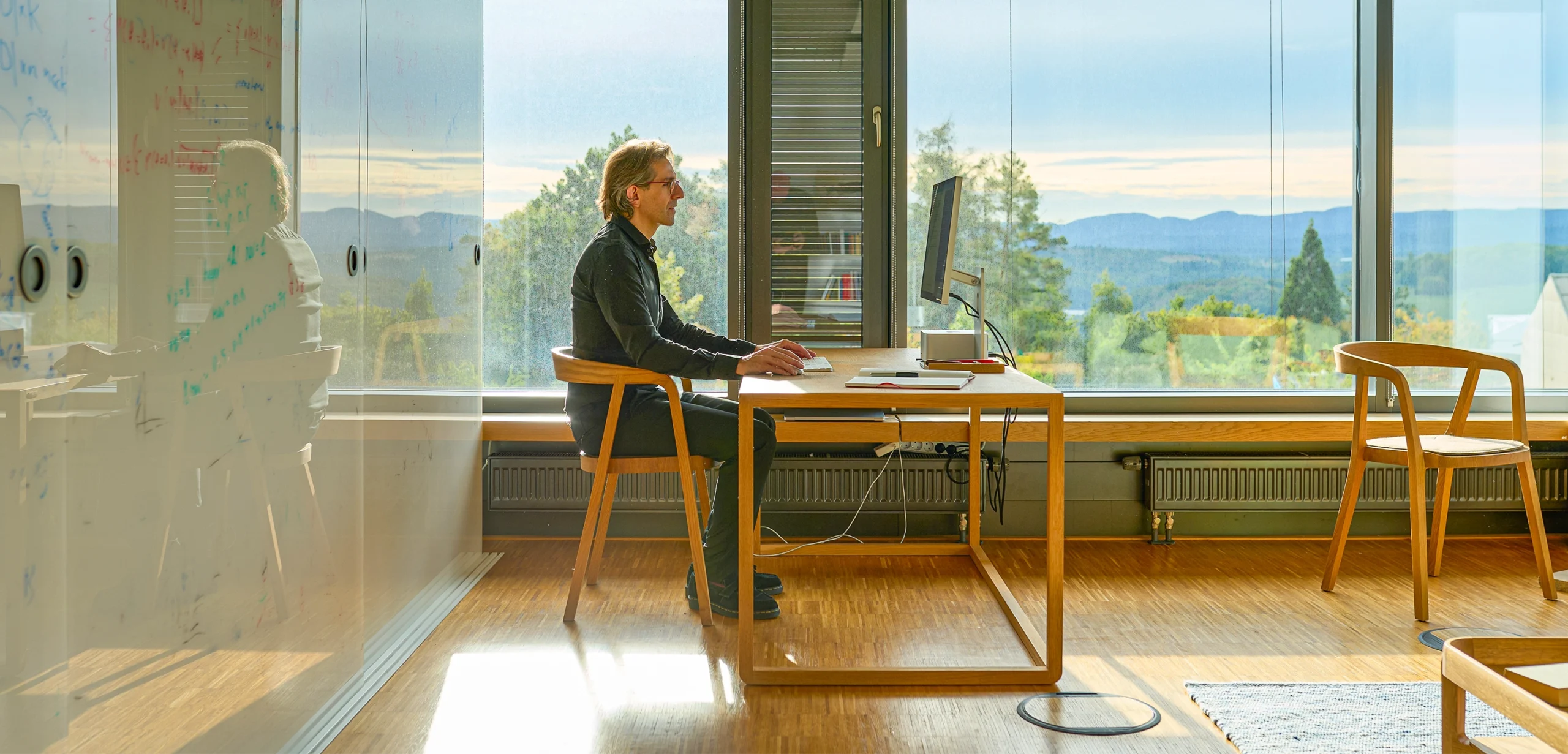 Man in profile, sitting at his computer.