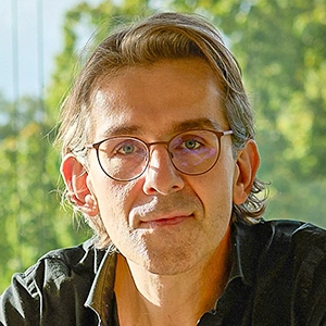 Man sitting on a green couch.