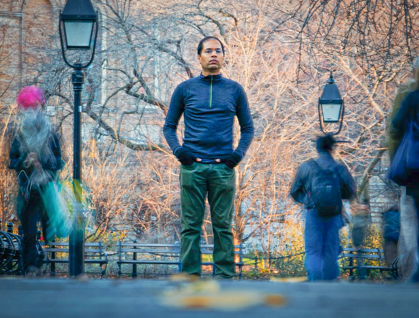 Man standing outside with his hands in his pockets.