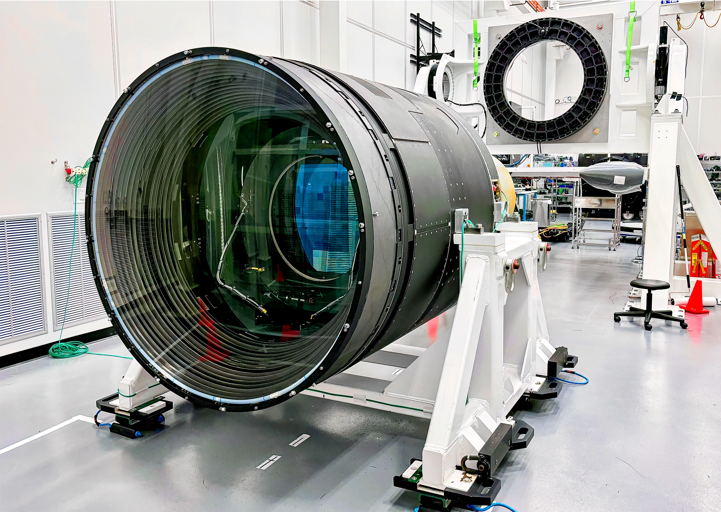 A car-size lens sitting in a clean room.