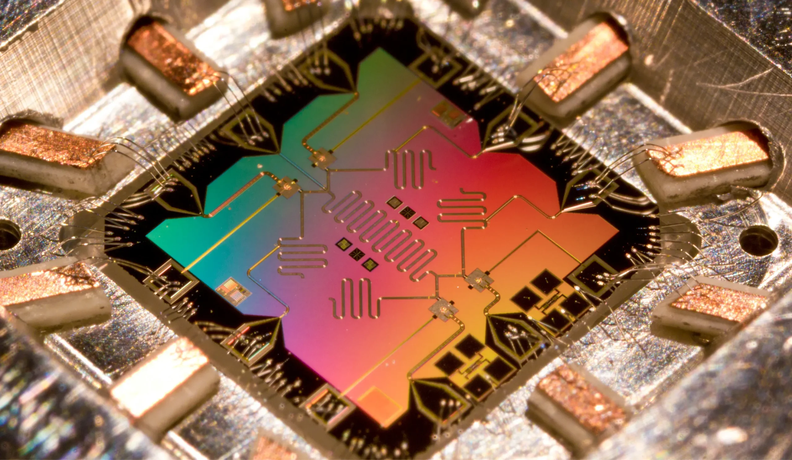 A quantum chip with circuit patterns, iridescent in rainbow colors.
